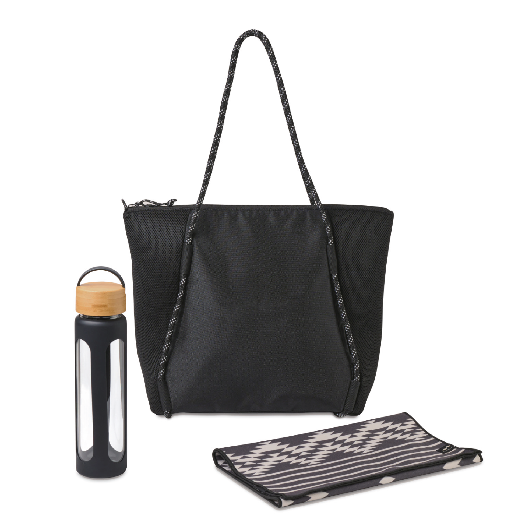 Image of black Slowtide fitness towel, glass water bottle and black tote bag.