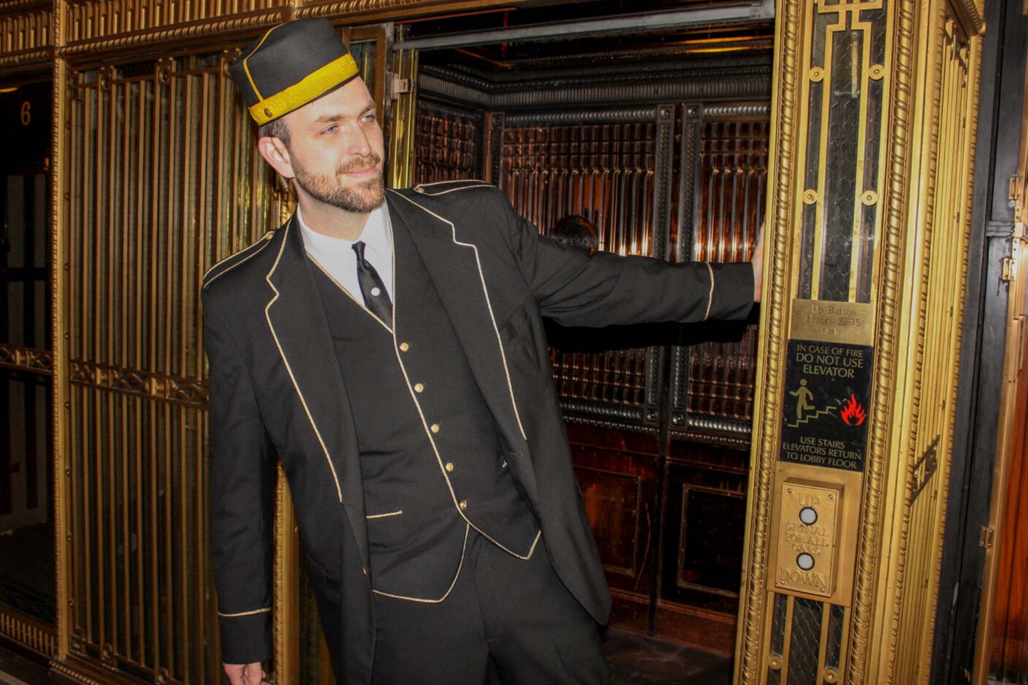 Image of man wearing elevator uniform