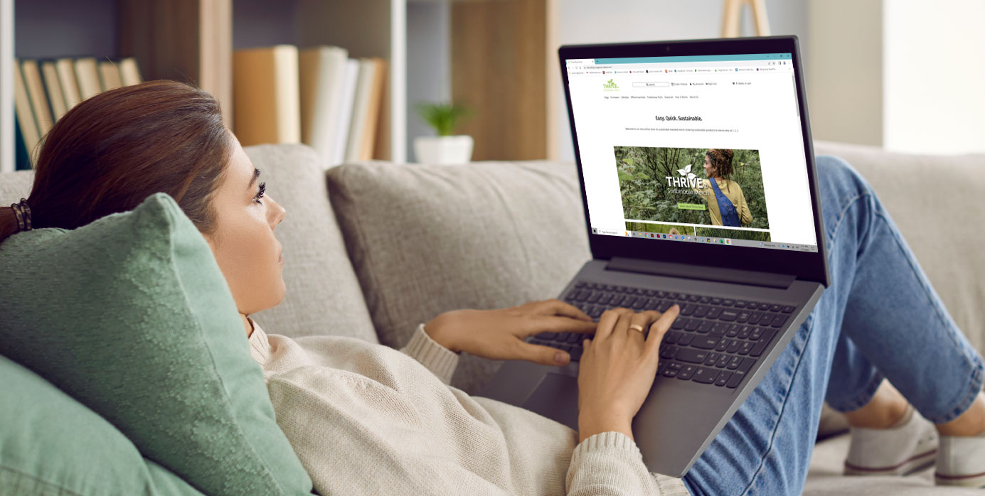 women on couch browsing on computer