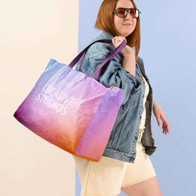 Women carrying fully custom tote that is blue, purple and orange.