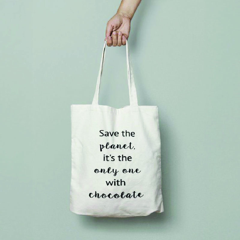 White canvas bag that says: Save the planet, it's the only one with chocolate.