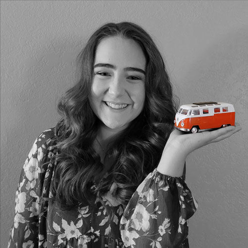 Kaley DeWeese holding a VW bus.