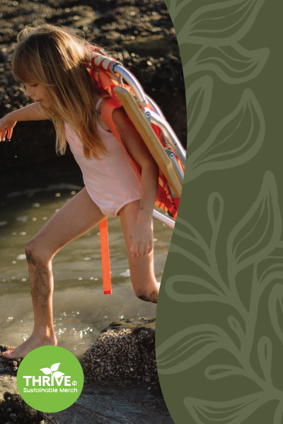Girl crossing creek with beach chair on her back.
