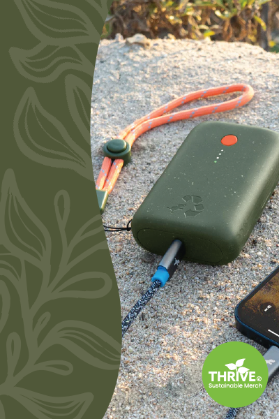 Green recycled power bank sitting on a rock.