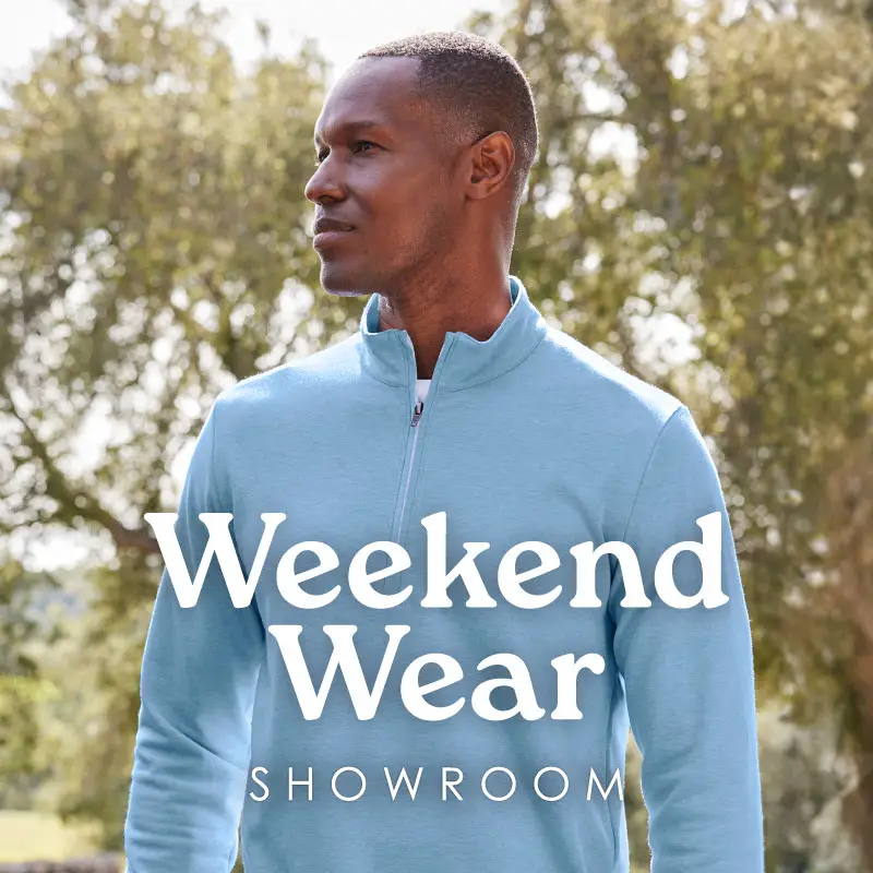 Man wearing light blue sweater outside.