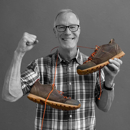 Tom Haven holding hiking shoes