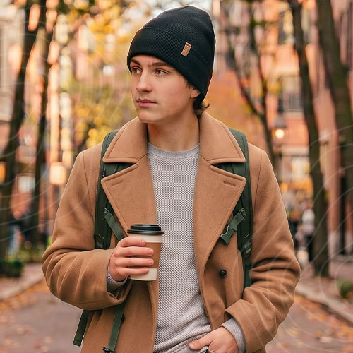 Useful_Square Man wearing beanie walking down a street in the fall.